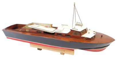 A wooden model long boat, painted in black and red, 87cm wide.