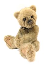 A Charlie Bears light brown bear, with bell collar, bearing label, 43cm high.