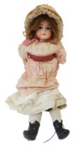 A German bisque headed porcelain doll, with brown fixed eyes and open mouth stamped Germany, with ma