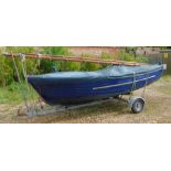 A 12ft blue G.R.P Clinker Sailing Dingy, with a mahogany gunwale with brass fittings, with Neil Pryd