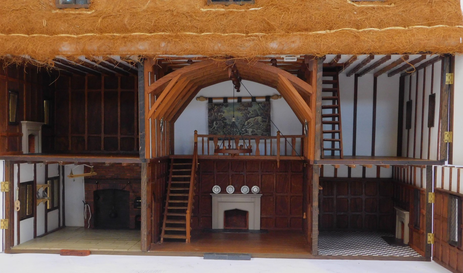 A three storey substantial Tudor style doll's house, with three chimneys, thatched roof, in painted - Image 3 of 10