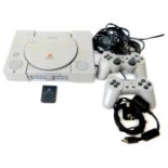 A Sony Playstation model SCPH7002 console, Sony Playstation DualShock analogue controller, other con