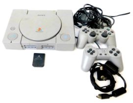 A Sony Playstation model SCPH7002 console, Sony Playstation DualShock analogue controller, other con