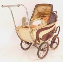 A vintage doll's pram, steel framed with cream and brown painted decoration, and a painted papier ma