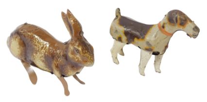 Two tinplate clockwork animals, comprising a British made hopping hare, and a German DRSM dog, lacki