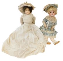A 19thC continental porcelain headed doll, unmarked, with fixed painted eyes and teeth, in lace gown