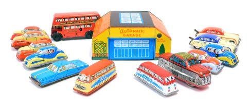 Tinplate models, comprising British made wind up cars, an automatic garage and a London red bus, no