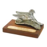 A Terraplane Griffin car mascot, used on both Hudsons and terraplanes, mounted on a rectangular wood