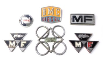 A collection of automobile badges, to include MF, Norton, BMC Diesel, Perkins Diesel, etc. (1 box)