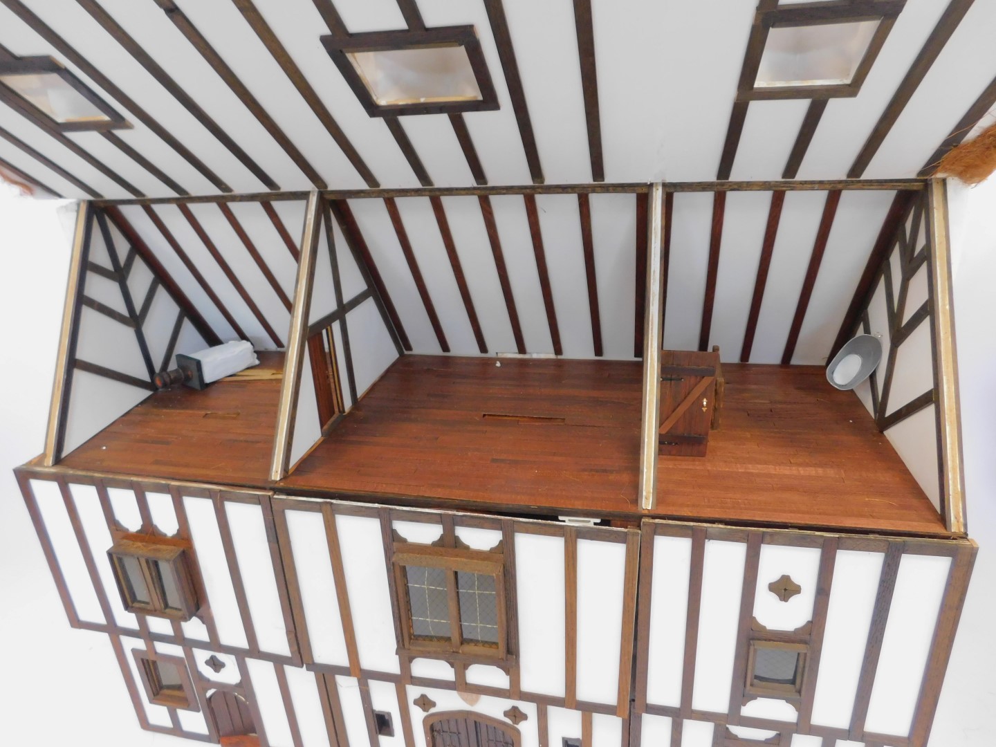 A three storey substantial Tudor style doll's house, with three chimneys, thatched roof, in painted - Image 2 of 10