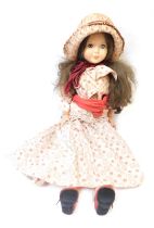 A 1960s/70s plastic formed doll, with roll eyes, and brown hair, in floral dress, 79cm high.