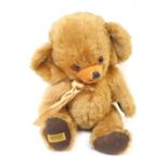 A Merry Thought blonde plush jointed Teddy bear, with amber eyes.