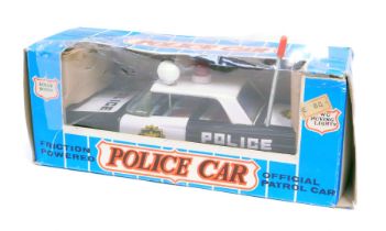 An Ichico of Korea friction powered tinplate police car, boxed.