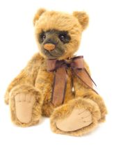 A Charlie Bears plush jointed Teddy bear, of two tone brown colouring, with bell bow collar, bearing