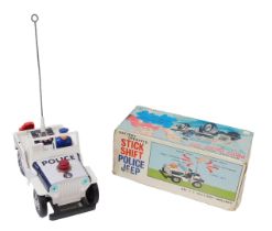 A Stick Shift battery operated police Jeep, boxed.