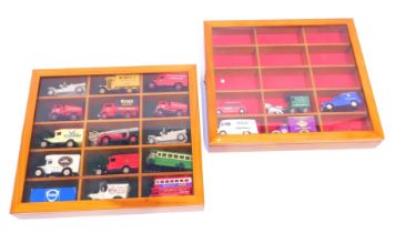 Two yew model car display cabinets, enclosing contents of Models of Yesteryear advertising buses and