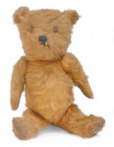 A vintage mohair Teddy bear, with felt pads and articulated arms and legs.