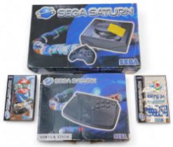 A Sega Saturn games console, boxed, a Sega Saturn Virtual Stick, boxed, and a Sega Rally Championshi