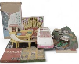 Toys and games, including a Barbie car, Fisher Price garage, Tracy Island play set with Thunderbird
