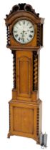 A Victorian oak longcase clock, with carved barley twist column hood, over a short trunk door with b