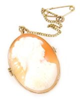 A 9ct gold oval cameo pendant, bust portrait of a lady, on a safety chain as fitted, 4.3g.