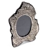 An Elizabeth II rococo silver strut photograph frame, embossed with flowers and sea scrolls, London