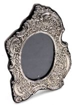 An Elizabeth II rococo silver strut photograph frame, embossed with flowers and sea scrolls, London