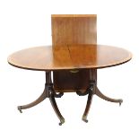 A Georgian style mahogany and yew wood cross banded oval twin pedestal dining table, with one additi