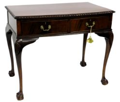 A mid 20thC mahogany serving table, the bow fronted top with a gadrooned edge above two frieze drawe