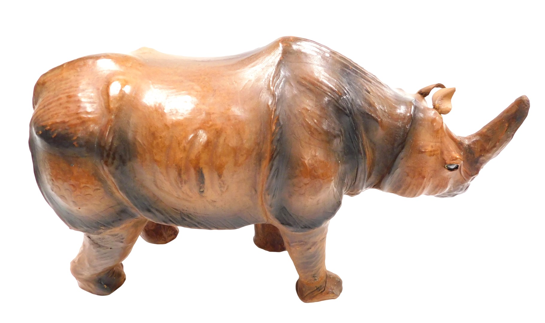 A vintage Liberty style leather bound wooden figure of a rhinoceros, with inset black eyes, 50cm wid