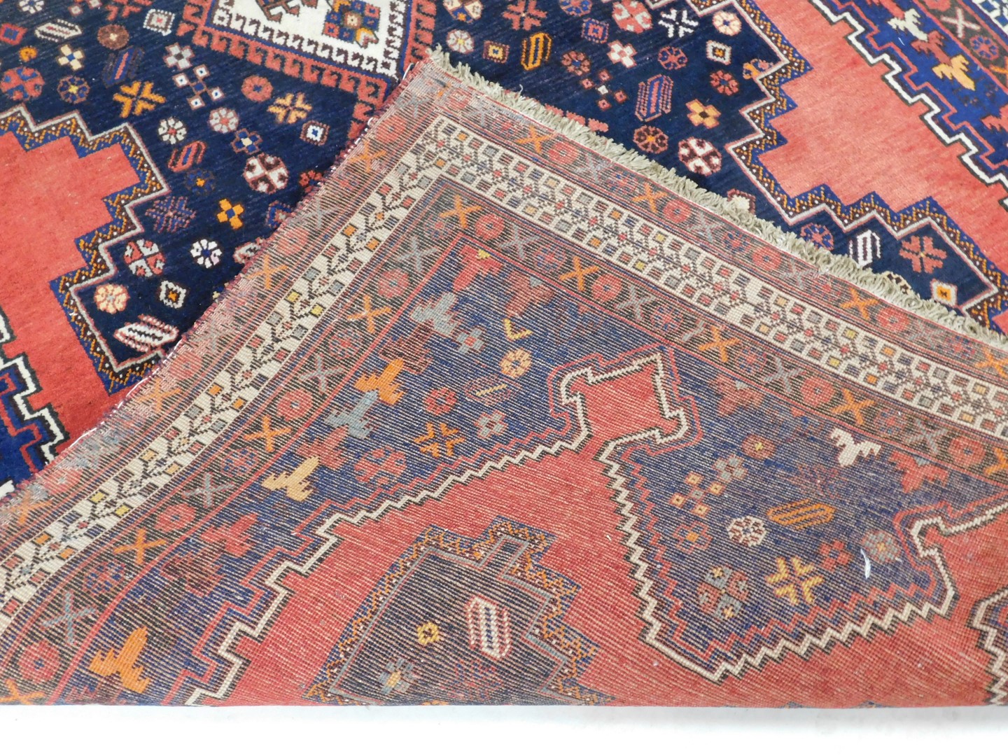 A Turkish design rug, with blue multi gul central field, on a red ground, 237cm x 159cm. - Image 3 of 3