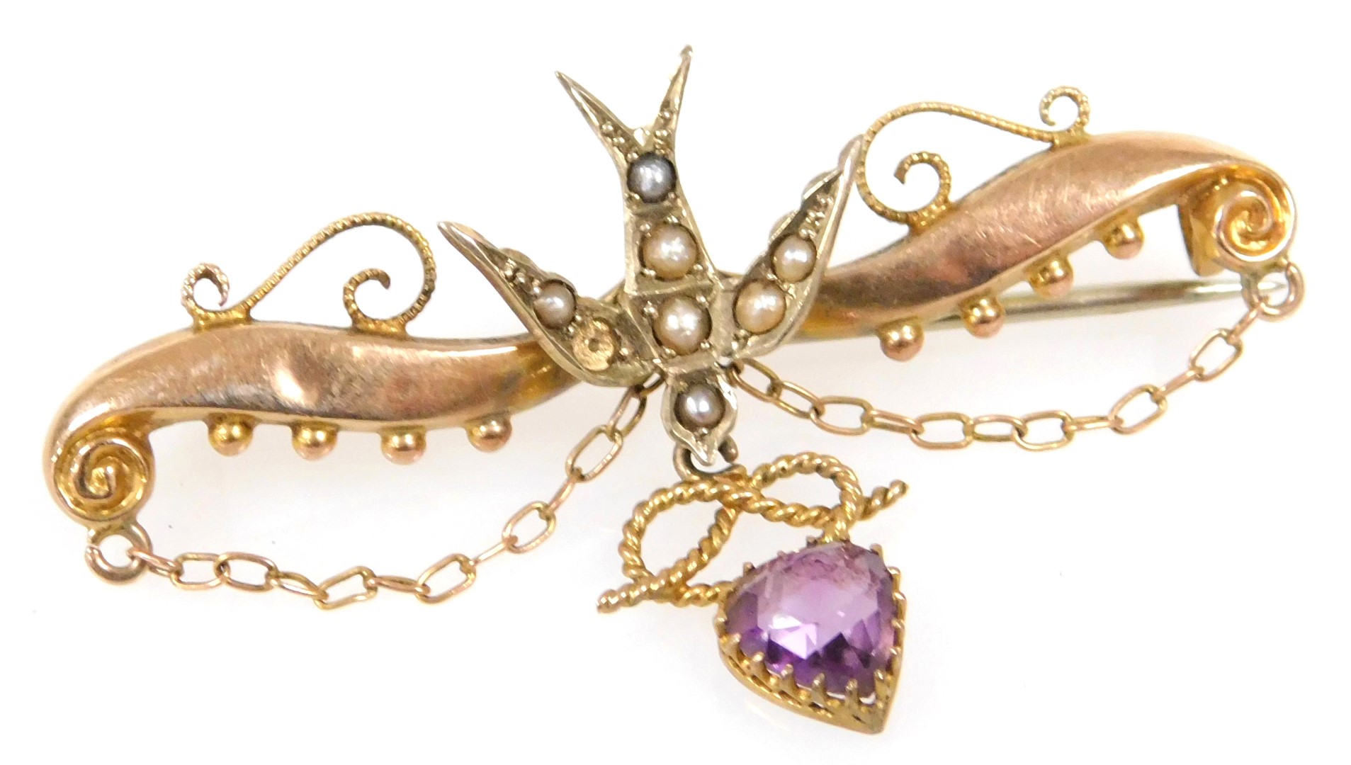 An Edwardian 9ct gold amethyst and seed pearl brooch, formed as a dove with a heart and knot drop, w