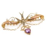 An Edwardian 9ct gold amethyst and seed pearl brooch, formed as a dove with a heart and knot drop, w
