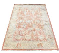 A Ziegler red and cream ground rug, decorated with floral and foliate motifs, within repeating flora