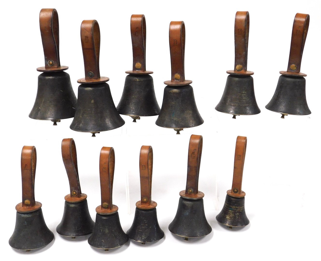 Twelve vintage graduated brass hand bells, with tan leather straps, denoting the note, cased. - Image 2 of 5