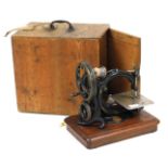 A Victorian Willcox and Gibbs sewing machine, pine cased with label.