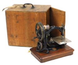A Victorian Willcox and Gibbs sewing machine, pine cased with label.