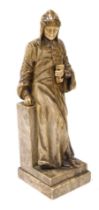 A 19thC alabaster figure of Dante Alighieri, modelled standing, leaning against a plinth, with a boo
