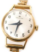 A Hamilton lady's 9ct gold case wristwatch, circular silver dial bearing Arabic numerals, on a 9ct g