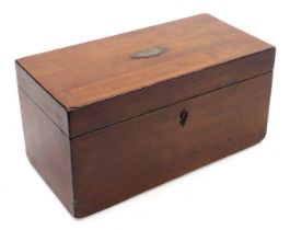 A Georgian mahogany tea caddy of rectangular section, the hinged lid opening to reveal a pair of lid