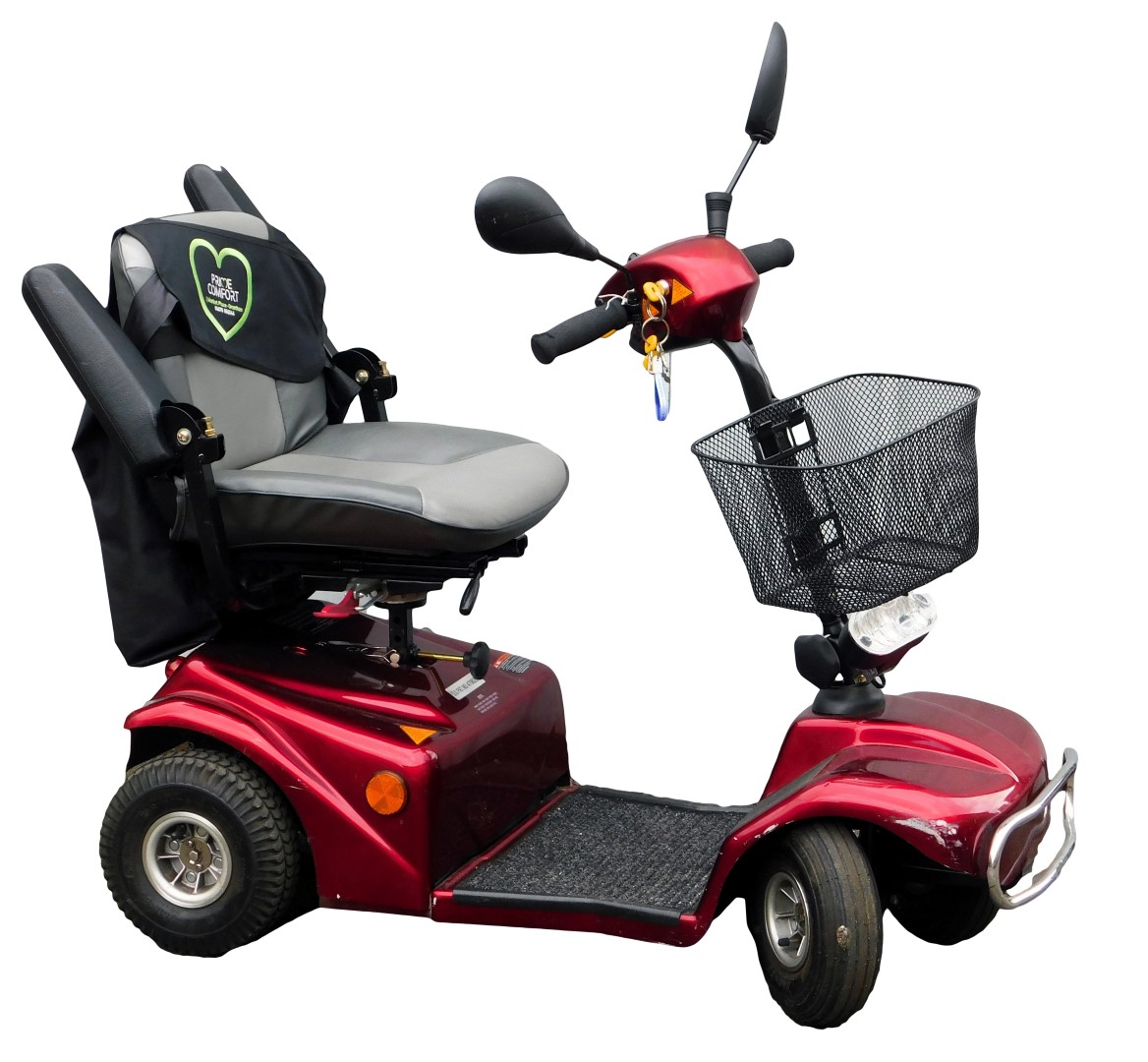 An electric mobility scooter with red paint work, and battery charger.
