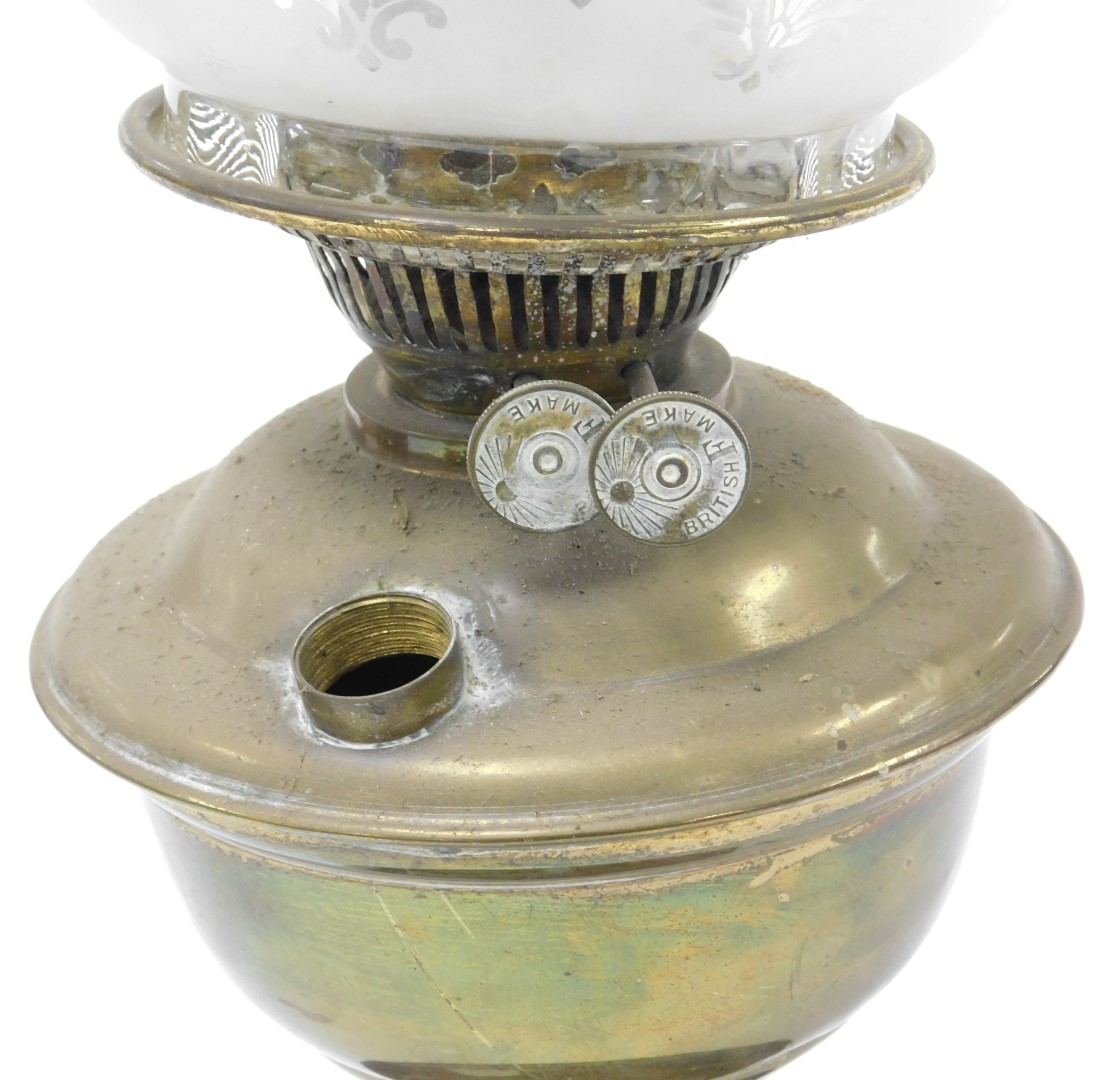 An early 20thC brass oil lamp, raised on a glass socle, with glass chimney and floral etched frilled - Image 2 of 2