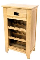 A light oak kitchen wine rack, with a frieze drawer above three section rack, on stiles, 101cm high,