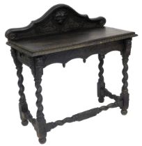 A late Victorian oak side table, the raised back carved with a mask, over a rectangular top with ste