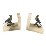 A pair of early 20th cold painted metal and onyx book ends, modelled with a pair of budgerigars, eac