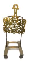 A 19thC brass and cast iron sliding trivet stand, with pierced foliate decoration, 42cm wide.