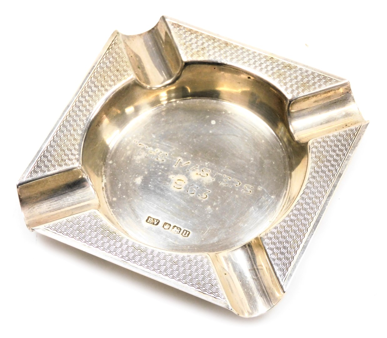 An Elizabeth II silver ashtray, with engine turned decoration, engraved centrally "The Masters" 1963