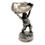 An early 20thC silver plated figure of the Skegness jolly fisherman, holding aloft an oyster shell,