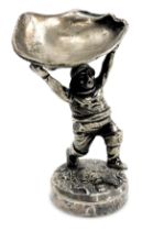 An early 20thC silver plated figure of the Skegness jolly fisherman, holding aloft an oyster shell,