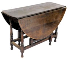 A late 18th/early 19thC oak oval gate leg table, on turned supports, 114cm wide.